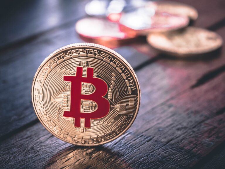 gold and red bitcoin on table 768x576.jpg